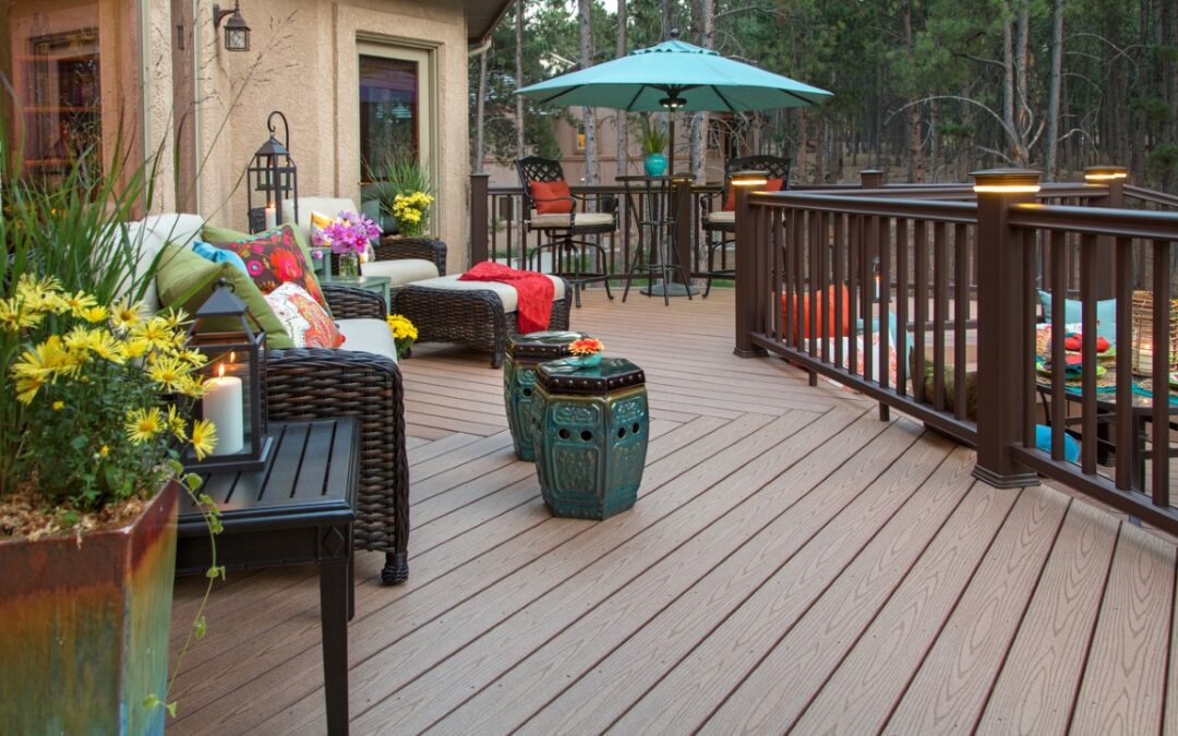 photo of backyard deck with plants and umbrella with table on it does composite decking fade